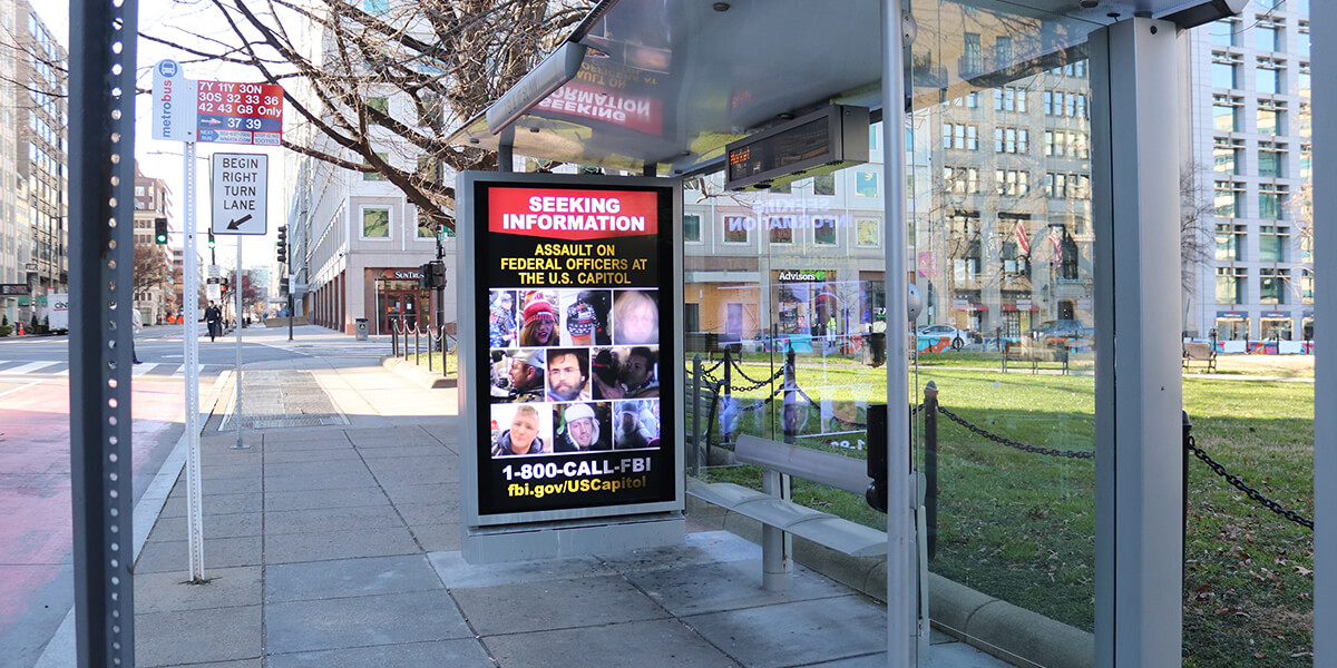 Bus-shelter advertisement seeking information on assault of federal officers at the U.S. Capitol. 1-800-CALL-FBI fbi.gov/USCapitol